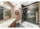 Bathroom featuring a soaking tub with glass shower, granite countertops, and modern lighting fixtures at 1050 Carnoustie Ln, Alpharetta, GA 30005