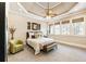 Bedroom featuring a ceiling fan, decorative wall art, large windows, and plush carpet at 1050 Carnoustie Ln, Alpharetta, GA 30005
