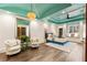 Bright bedroom boasts a unique tray ceiling with accent color, window seat, and stylish decor at 1050 Carnoustie Ln, Alpharetta, GA 30005