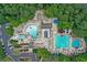Aerial shot of a community pool area featuring multiple pools, lounge chairs, and manicured landscaping at 1050 Carnoustie Ln, Alpharetta, GA 30005