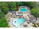 Aerial view of the community pool area with multiple pools, lounge chairs, and shaded seating at 1050 Carnoustie Ln, Alpharetta, GA 30005