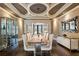 A formal dining room with modern lighting, wine storage, and a long wooden table at 1050 Carnoustie Ln, Alpharetta, GA 30005