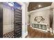 Hallway featuring an elevator with an intriguing scissor gate design, dark hardwood floors, and stylish interior design at 1050 Carnoustie Ln, Alpharetta, GA 30005