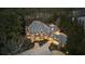 Beautiful exterior elevation of the estate surrounded by mature trees at 1050 Carnoustie Ln, Alpharetta, GA 30005