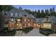 Charming brick home with manicured landscaping, cobblestone driveway, and well-lit entrance, creating a cozy and inviting atmosphere at 1050 Carnoustie Ln, Alpharetta, GA 30005