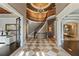 Stately foyer with checkered floors, a curved staircase, and a chandelier, exuding luxury and elegance at 1050 Carnoustie Ln, Alpharetta, GA 30005