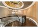 Elegant foyer with curved staircase, dark wood floors, and decorative chandelier at 1050 Carnoustie Ln, Alpharetta, GA 30005