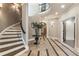 Elegant foyer with staircase, decorative tile inlay, and sophisticated lighting, creating a grand and welcoming entrance at 1050 Carnoustie Ln, Alpharetta, GA 30005