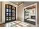 Grand foyer with marble flooring, custom double doors, and a glimpse of the living room with a fireplace at 1050 Carnoustie Ln, Alpharetta, GA 30005