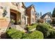 Close up of a lovely entryway with brick and stonework, with beautiful garden and lawn design elements at 1050 Carnoustie Ln, Alpharetta, GA 30005
