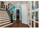 Hallway with stairway, hardwood floors, and built-in white cabinets at 1050 Carnoustie Ln, Alpharetta, GA 30005