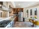 Well-equipped kitchen with stainless steel appliances, granite countertops, and a bright breakfast nook overlooking the yard at 1050 Carnoustie Ln, Alpharetta, GA 30005