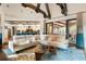 Cozy living room with a white sofa, hardwood floors, and access to outdoor patio at 1050 Carnoustie Ln, Alpharetta, GA 30005