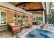 Inviting covered outdoor living space featuring lounge area, dining space and refreshing spa pool at 1050 Carnoustie Ln, Alpharetta, GA 30005