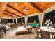 Picturesque covered patio offering comfortable seating, dining area, and pool views at 1050 Carnoustie Ln, Alpharetta, GA 30005