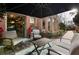 Charming patio with brick paving, comfortable seating, and lush greenery, perfect for outdoor relaxation and entertainment at 1050 Carnoustie Ln, Alpharetta, GA 30005