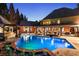 Night view of a serene backyard pool area with an illuminated pool, patio, and outdoor seating for peaceful evenings at 1050 Carnoustie Ln, Alpharetta, GA 30005