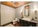 Chic powder room with patterned wallpaper, modern vanity, and decorative lighting at 1050 Carnoustie Ln, Alpharetta, GA 30005