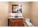 Stylish powder room with custom vanity, vessel sink, decorative mirror, and elegant wall texture at 1050 Carnoustie Ln, Alpharetta, GA 30005