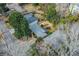 The aerial view shows a home with mature trees surrounding it and a nearby road at 42 W Belle Isle Ne Rd, Atlanta, GA 30342