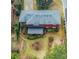 Aerial view of a home with red siding, gray roof, a small shed, and garden landscaping at 42 W Belle Isle Ne Rd, Atlanta, GA 30342