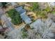 This aerial view shows a home with a well-manicured lawn, mature trees, and a road at 42 W Belle Isle Ne Rd, Atlanta, GA 30342