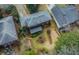 An aerial view shows a home with red siding, a dark gray roof, a shed, and garden at 42 W Belle Isle Ne Rd, Atlanta, GA 30342
