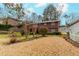 Spacious backyard with healthy lawn, mature trees, and established landscaping at 42 W Belle Isle Ne Rd, Atlanta, GA 30342