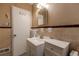 Bathroom featuring a white sink vanity, tile walls, and well-lit mirror at 42 W Belle Isle Ne Rd, Atlanta, GA 30342