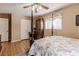 Bright bedroom featuring wood floors, a ceiling fan, and a four-poster bed with floral bedding at 42 W Belle Isle Ne Rd, Atlanta, GA 30342