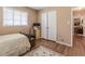 Bedroom featuring light wood floors, closet, and a window with blinds at 42 W Belle Isle Ne Rd, Atlanta, GA 30342