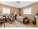 Cozy bedroom with wooden floors, two bright windows, and a rocking chair at 42 W Belle Isle Ne Rd, Atlanta, GA 30342