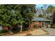 Cozy single-story home with a covered porch, mature landscaping, and a well-maintained yard at 42 W Belle Isle Ne Rd, Atlanta, GA 30342