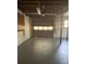 This basement features a garage with a door, concrete floor, and windows at 536 Joann Ave, Austell, GA 30168