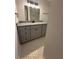 Bathroom featuring gray vanity with granite countertop, modern fixtures, and stylish mirror at 536 Joann Ave, Austell, GA 30168