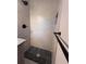 The modern bathroom has gray tile and a black shower head at 536 Joann Ave, Austell, GA 30168