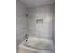 Stylish bathroom with tub, shower, and tiled walls, and recessed shelf at 536 Joann Ave, Austell, GA 30168
