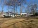 Charming single story home with attached carport and mature trees in front yard at 536 Joann Ave, Austell, GA 30168