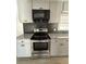 Well-lit kitchen features stainless steel appliances, granite countertops, and modern gray backsplash and cabinetry at 536 Joann Ave, Austell, GA 30168