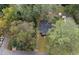 An aerial view of the home surrounded by mature trees and lush greenery at 2458 Calvin Ave, East Point, GA 30344