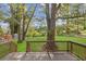 Large backyard with wooden deck, lawn and mature trees at 2458 Calvin Ave, East Point, GA 30344