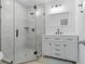 Modern bathroom features a glass enclosed shower and white vanity with black hardware at 2458 Calvin Ave, East Point, GA 30344