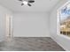 Bright bedroom with new vinyl flooring, ceiling fan, and large window showcasing the outdoors at 2458 Calvin Ave, East Point, GA 30344