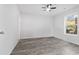 Bedroom featuring new flooring, ceiling fan and window at 2458 Calvin Ave, East Point, GA 30344