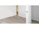 Empty room showing updated flooring, door and baseboards at 2458 Calvin Ave, East Point, GA 30344