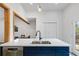 Kitchen with a large island, quartz countertop, stainless steel appliances, and a sink overlooking the backyard at 2458 Calvin Ave, East Point, GA 30344