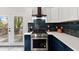 Kitchen featuring stainless steel appliances, a gas range, quartz countertop, and backyard access at 2458 Calvin Ave, East Point, GA 30344