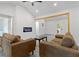 Living room with vaulted ceiling has comfortable seating and a contemporary electric fireplace for cozy ambiance at 2458 Calvin Ave, East Point, GA 30344