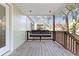 Relaxing porch view featuring a comfortable porch swing and wooden railing at 2458 Calvin Ave, East Point, GA 30344