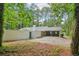 Large backyard with an enclosed fence, brick, mature trees, and greenery at 2950 Duke Of Gloucester, Atlanta, GA 30344